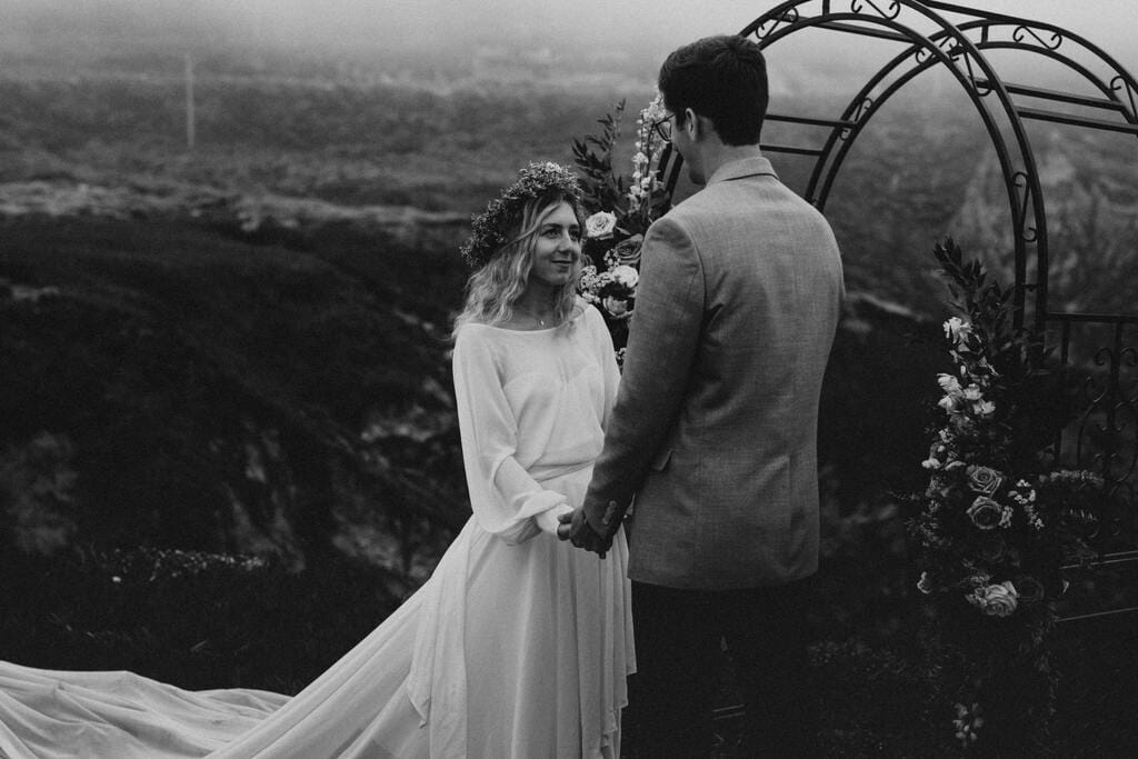 Madison + Kanyon Bride and groom exchanging vows by the sea in California.