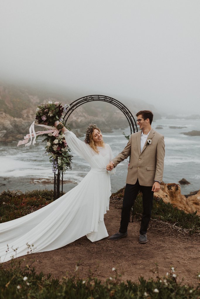 Madison + Kanyon Bride holds up her bouquet celebrating her marriage.