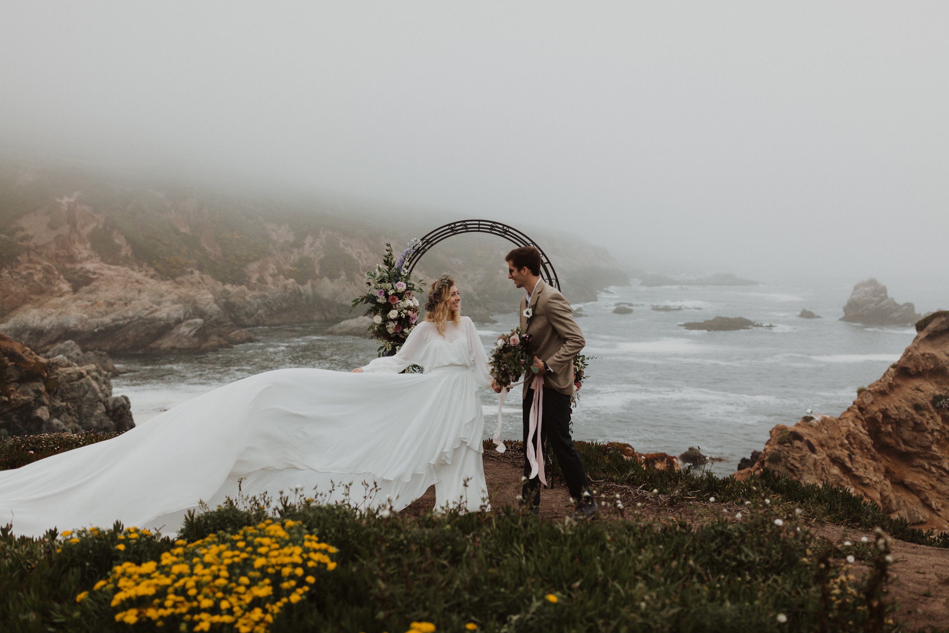 Madison + Kanyon Harriett Falvey boho bridal dress flowing in the wind during ceremony.