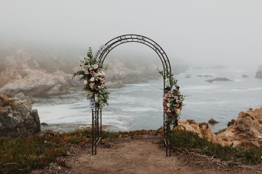 Madison + Kanyon elopement arch for a seaside wedding ceremony.