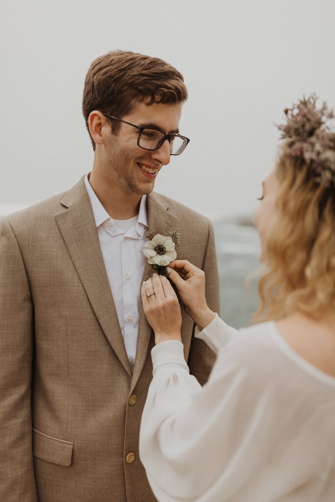 Madison + Kanyon Bride adjust boutonniere on groom.