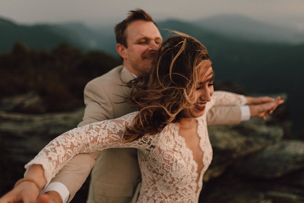 monica leavell photo linville gorge wilderness north carolina adventure elopement 037 couple celebrate together on top of north Carolina mountain.