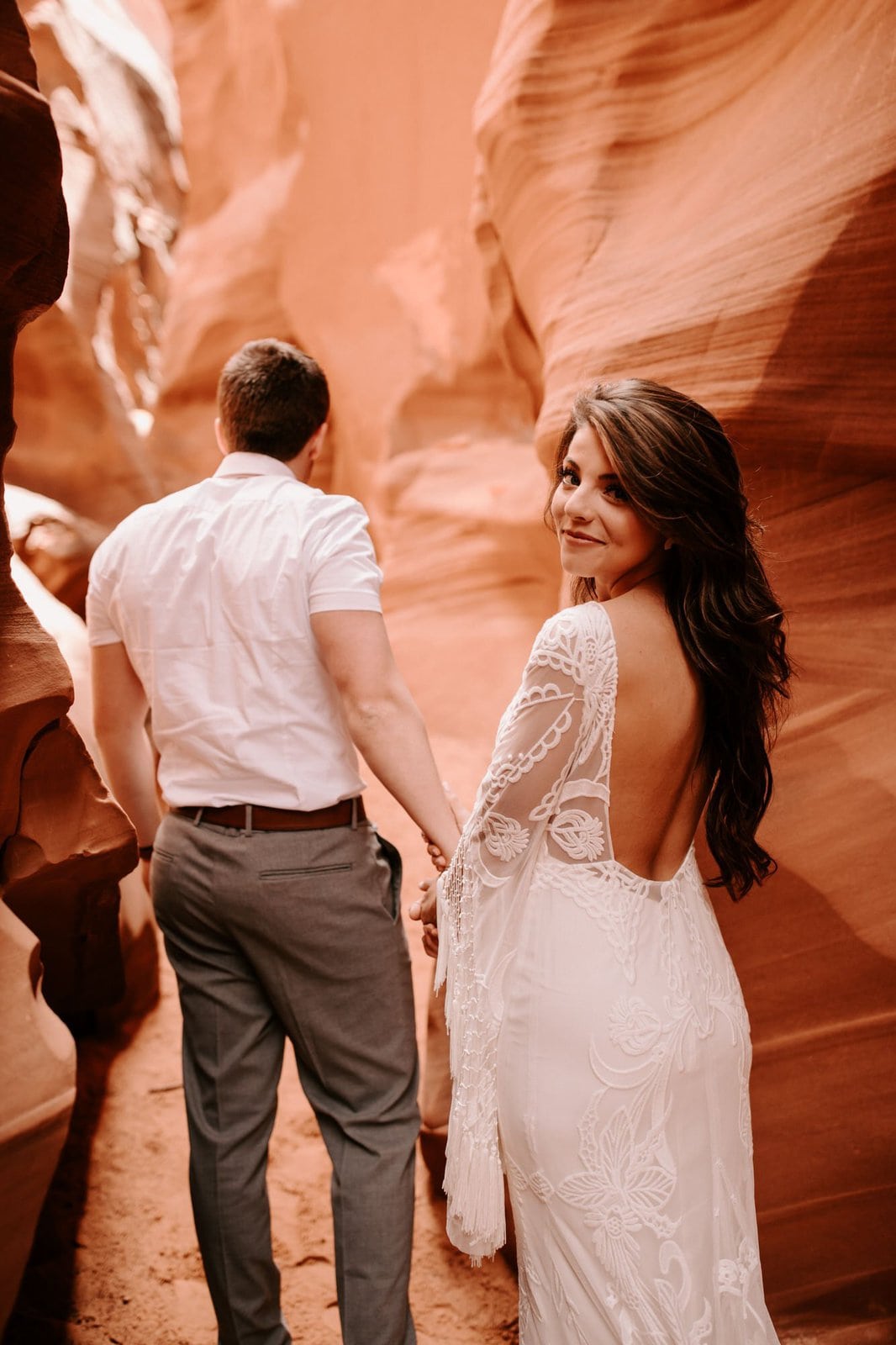 Savanna-Kaye-Horseshoe-Bend-Antelope-Canyon-Elopement_Arizona-2871 bride and groom walking in Antelope Canyon.