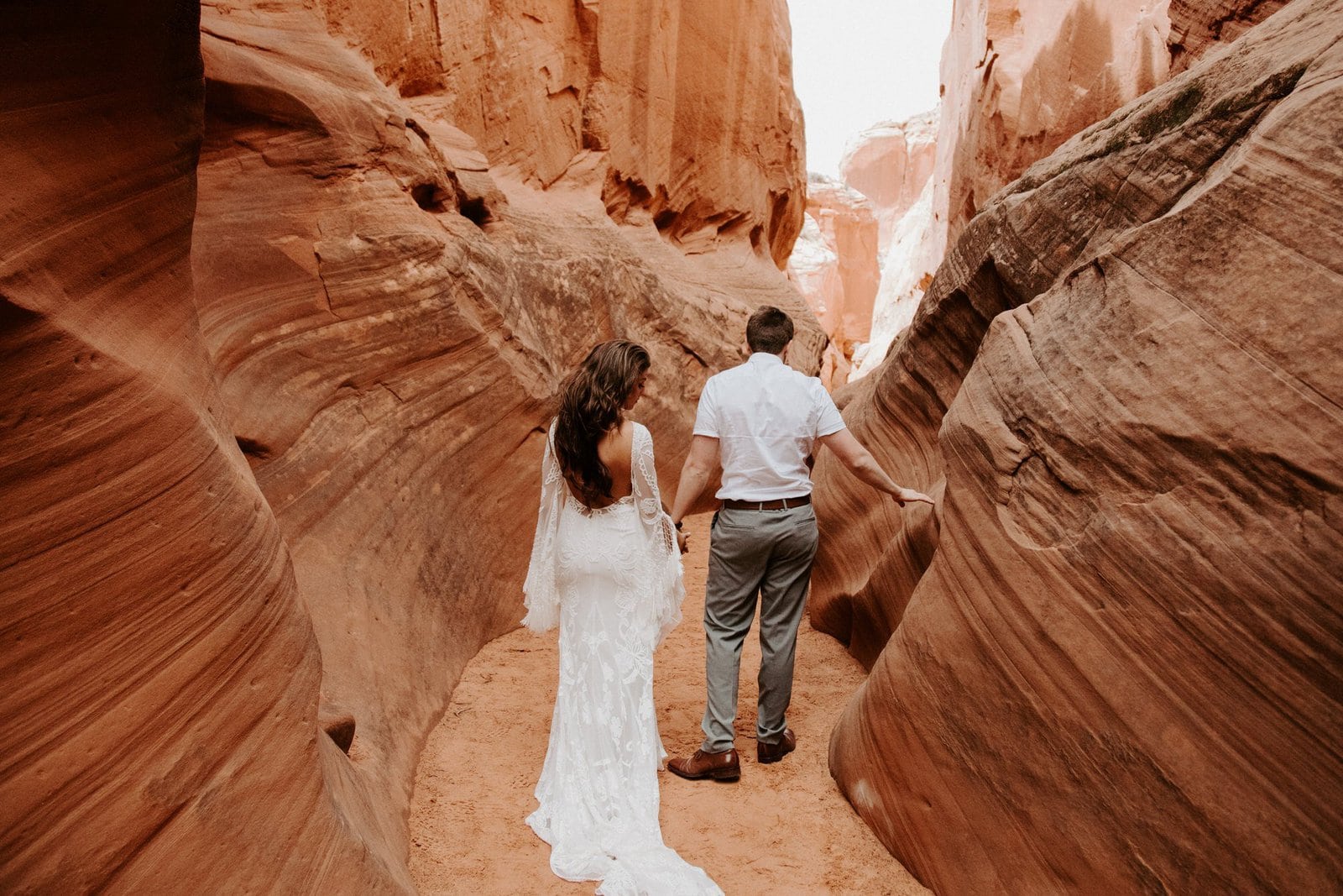 Savanna-Kaye-Horseshoe-Bend-Antelope-Canyon-Elopement_Arizona-4143 Bride and groom walk in antelope canyon.