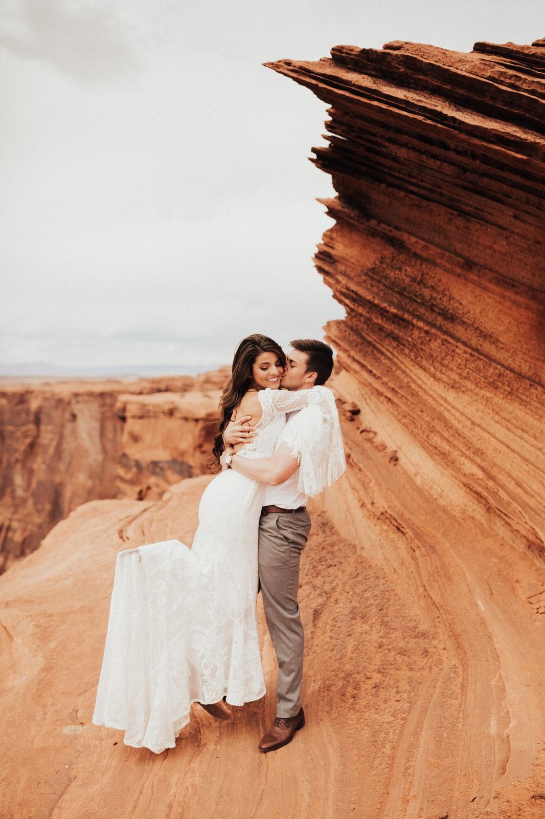 Savanna-Kaye-Horseshoe-Bend-Antelope-Canyon-Elopement_Arizona-4610 groom picks up his bride for intimate portraits.