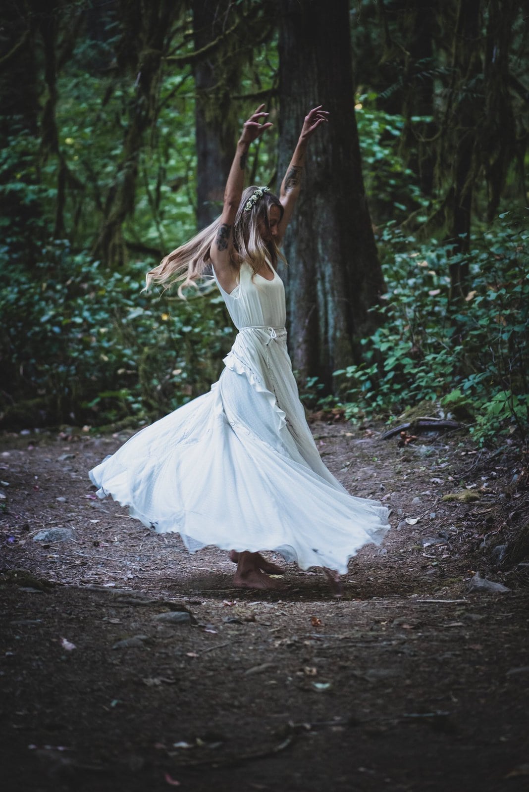 Detail shot of bride twirling in the forest.