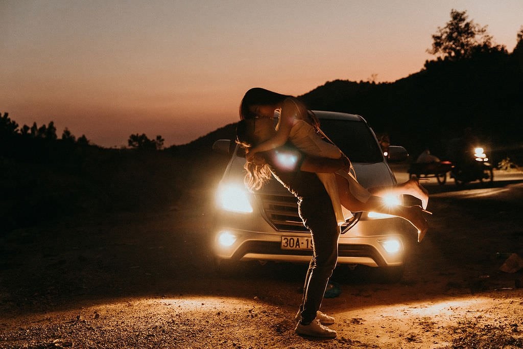 bride and groom kiss at night