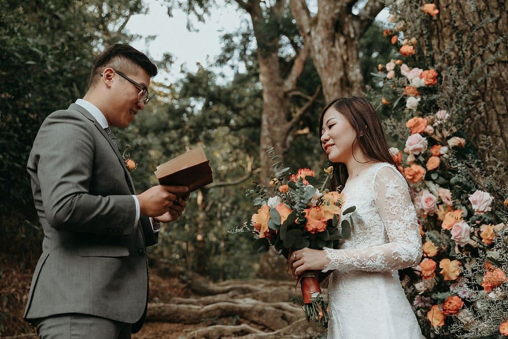 groom reads vows to bride.