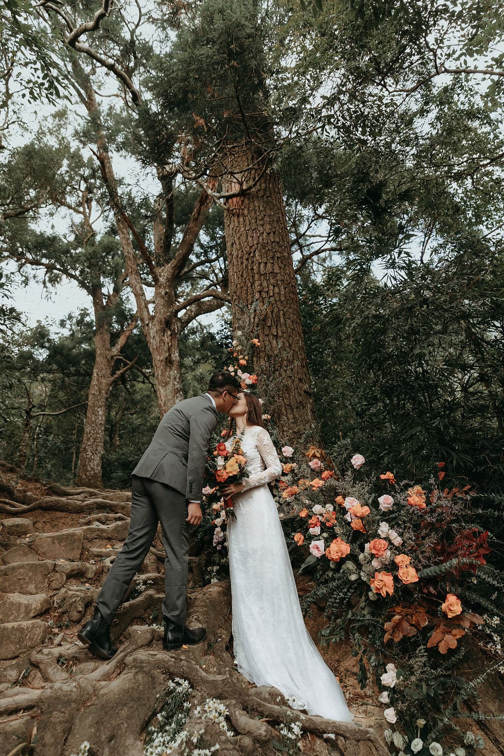 bride and groom kiss during Vietnam wedding ceremony.