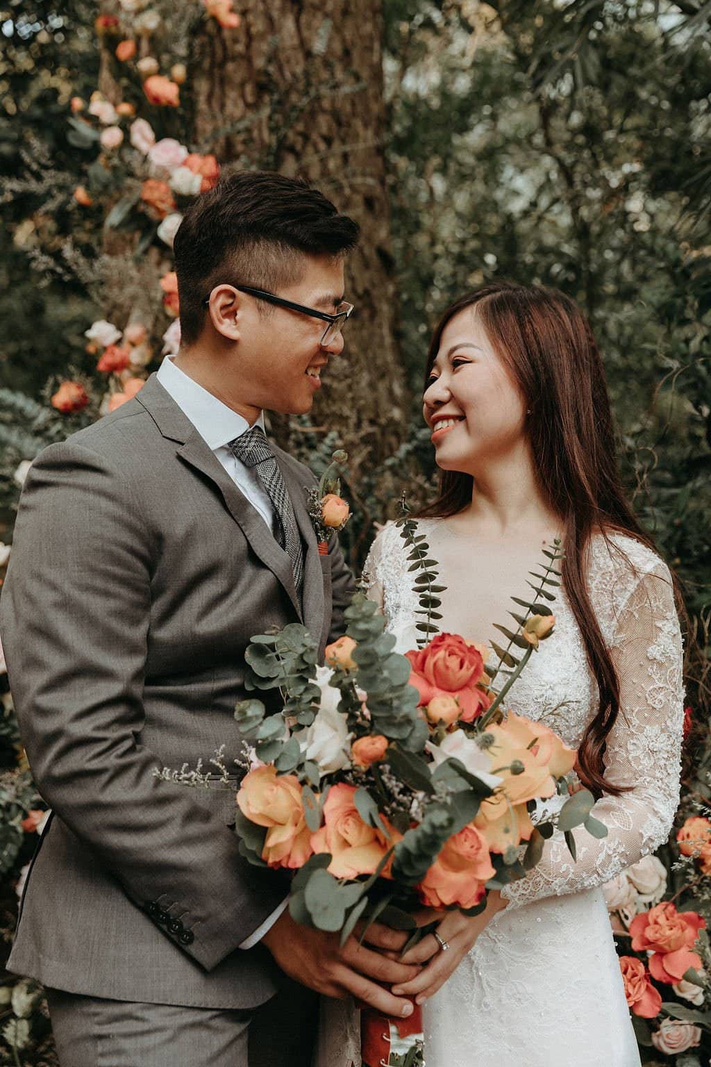 bride and groom smiling.