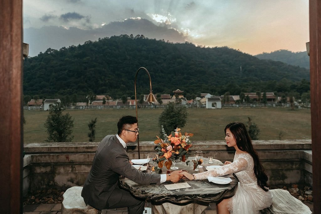bride and groom eating during Vietnam wedding