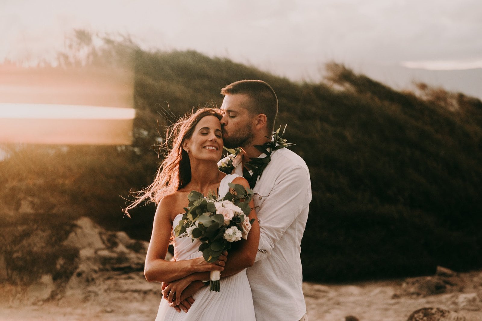 maui wedding photography-57 groom kisses his bride as sun sets