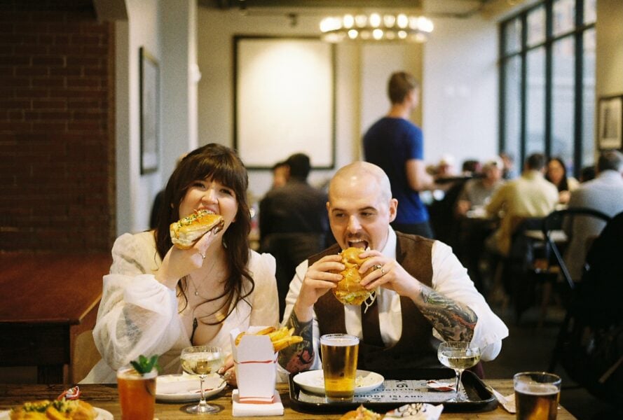 Bride and groom eating their elopement dinner at Track 15 in Providence, RI. Photo by Rhode Tripper Photography
