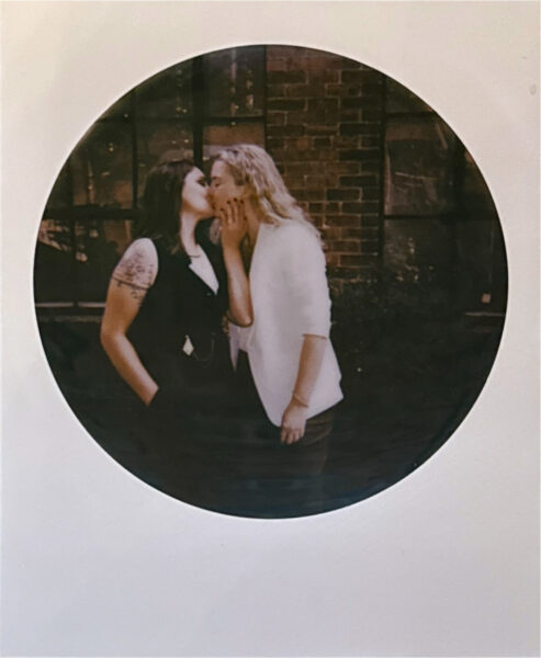 Queer eloping couple kissing on a Polaroid. Photo by Rhode Tripper Photography.
