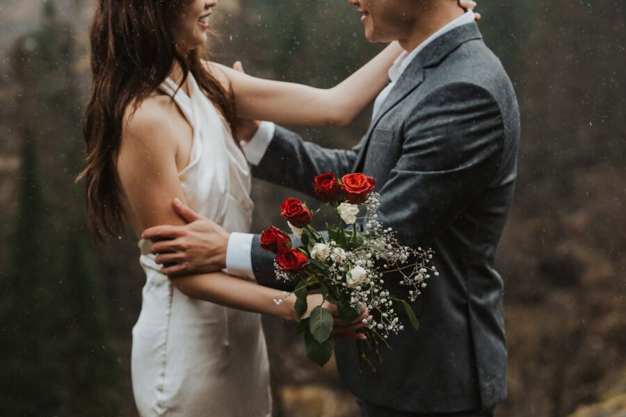 elopement couple embracing in the rain