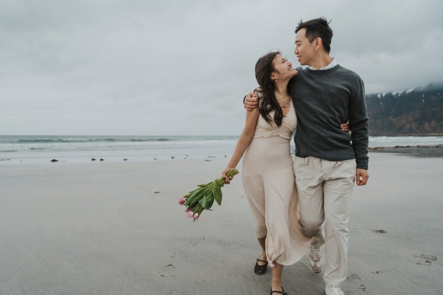 elopement couple walking on a beach in lofoten