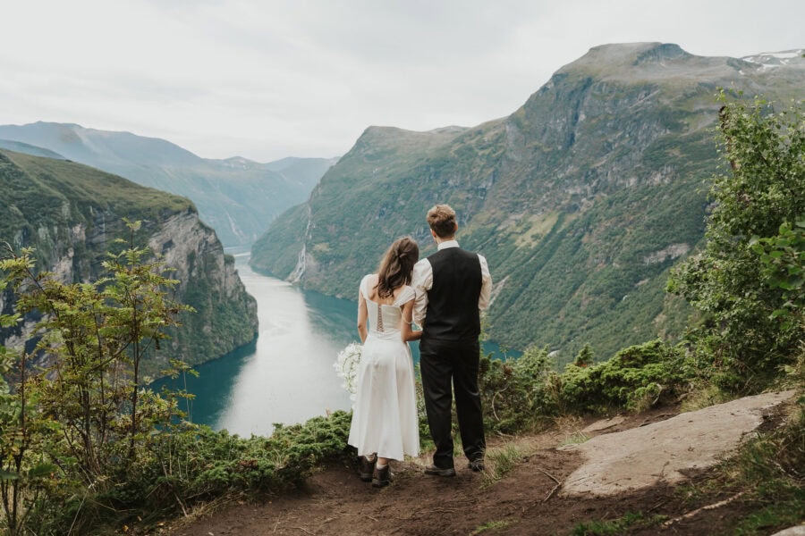 elopement couple looking at the fjords in geiranger norway