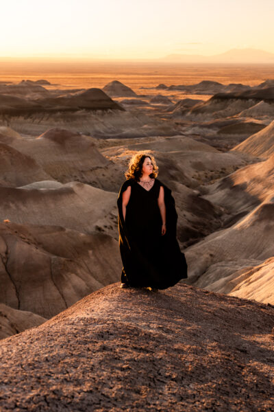 In the vastness of Arizona’s Painted Desert, a couple’s love takes center stage, with one partner in a striking black wedding dress.