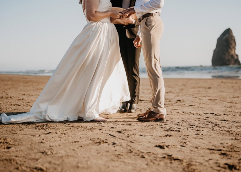 elopement couple share vows on cannon beach on the oregon coast.