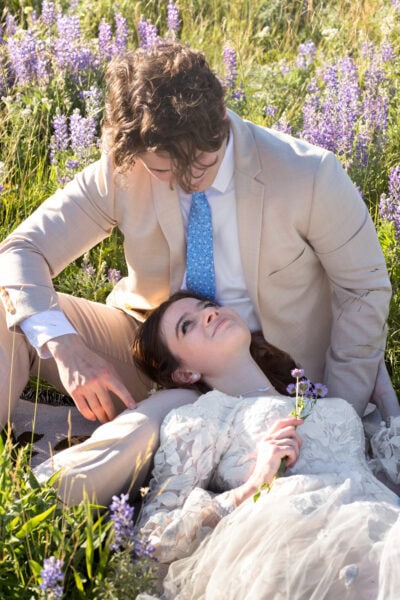 A couple is enjoying their time together on the flowers in Waterton Lakes. 