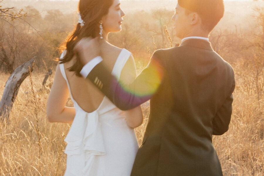 Bride and groom bathed in golden light while sharing a moment during their safari elopement in South Africa.