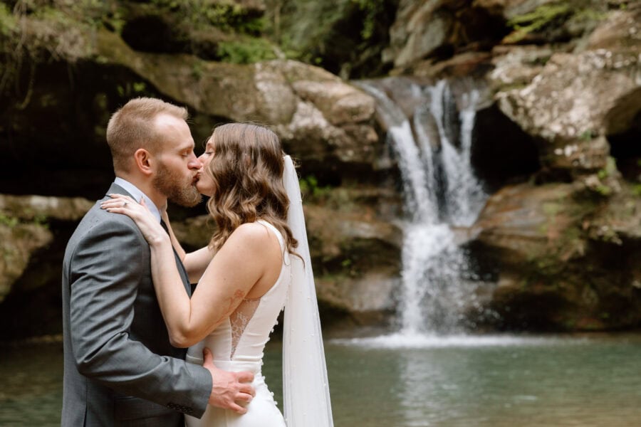 Couple kissing next to the waterfall at Old Man's Cave