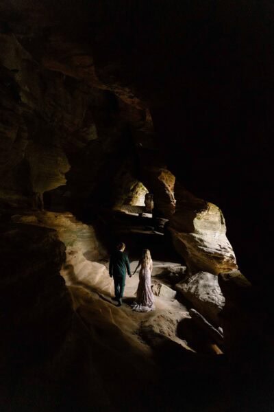 Couple holding hands in Rock House Cave in Hocking Hills