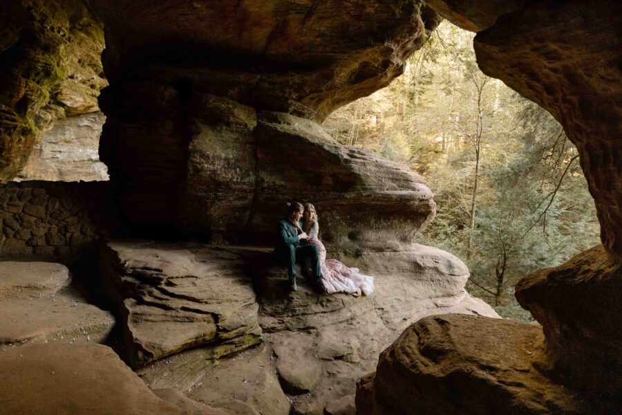 Couple sitting on a ledge at Rock House.